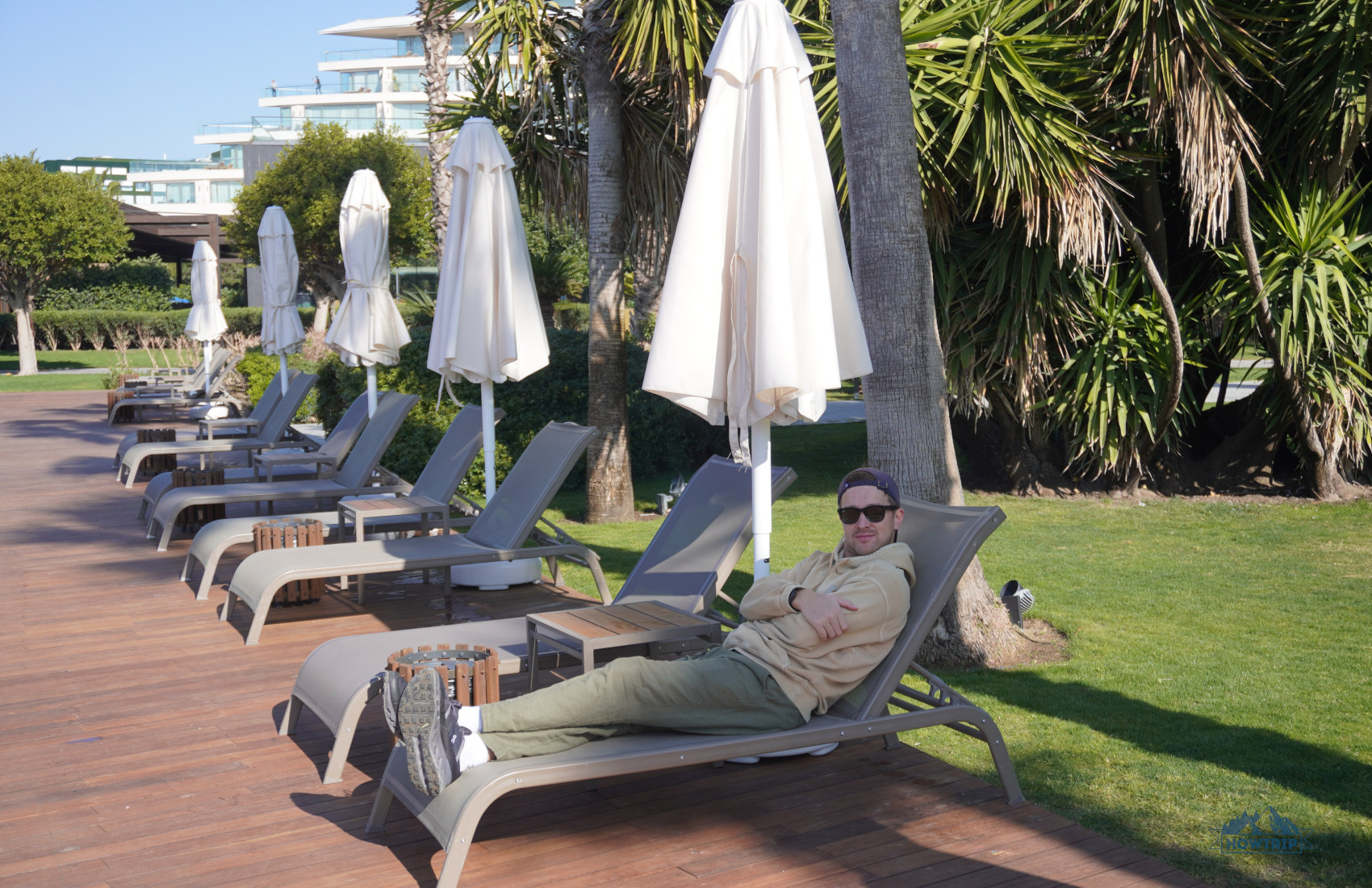 на лежаке у бассейна Voyage Belek Golf and Spa